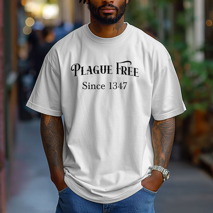 Person wearing a White T-shirt with a humorous Renaissance Faire design that reads “Plague Free Since 1347” in medieval-style lettering, celebrating fair and festival fun with a nod to history. A playful shirt perfect for history buffs, medieval enthusiasts, and anyone attending a Renaissance fair or themed event.