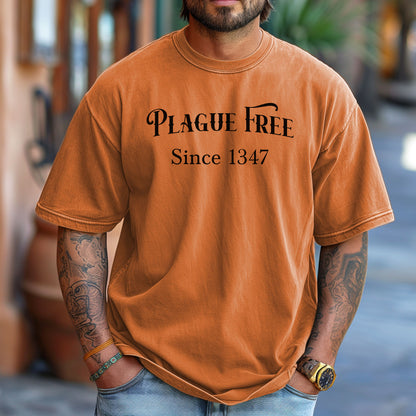 Person wearing a Yam T-shirt with a humorous Renaissance Faire design that reads “Plague Free Since 1347” in medieval-style lettering, celebrating fair and festival fun with a nod to history. A playful shirt perfect for history buffs, medieval enthusiasts, and anyone attending a Renaissance fair or themed event.