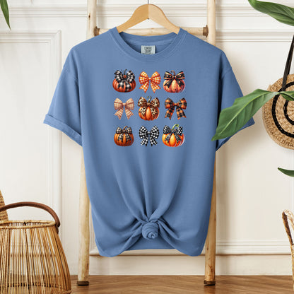 Washed Denim T-shirt featuring “Pumpkins and Coquette Bows” design. The artwork displays a grid of pumpkins and decorative coquette bows in plaid, gingham, and fall patterns, blending rustic autumn charm with a playful coquette aesthetic. Perfect for celebrating fall fashion and cozy seasonal vibes with a cute, stylish twist.