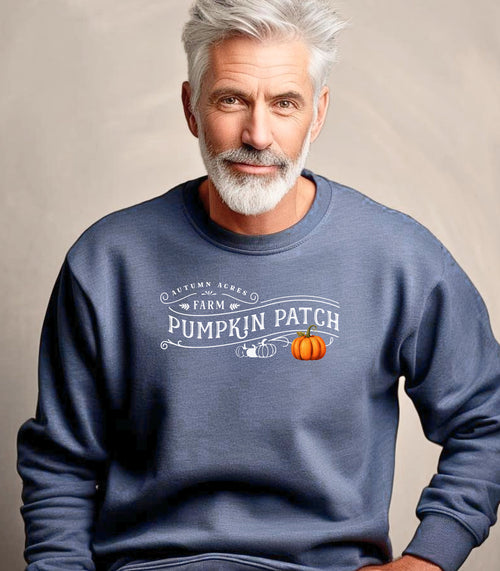 Heather Sport Dark Navy Gildan sweatshirt featuring a vintage-inspired white “Autumn Acres Farm Pumpkin Patch” design with decorative swirls and white and orange pumpkins—on the side. A cozy, rustic fall look perfect for pumpkin picking, hayrides, and seasonal outings.