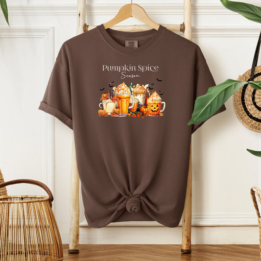 Espresso T-shirt featuring a “Pumpkin Spice Season” design with colorful autumn drinks topped with whipped cream, surrounded by pumpkins, jack-o’-lanterns, fall leaves, and flying bats. The cozy, festive artwork celebrates the love for pumpkin spice and autumn vibes, perfect for seasonal wear and fall enthusiasts.