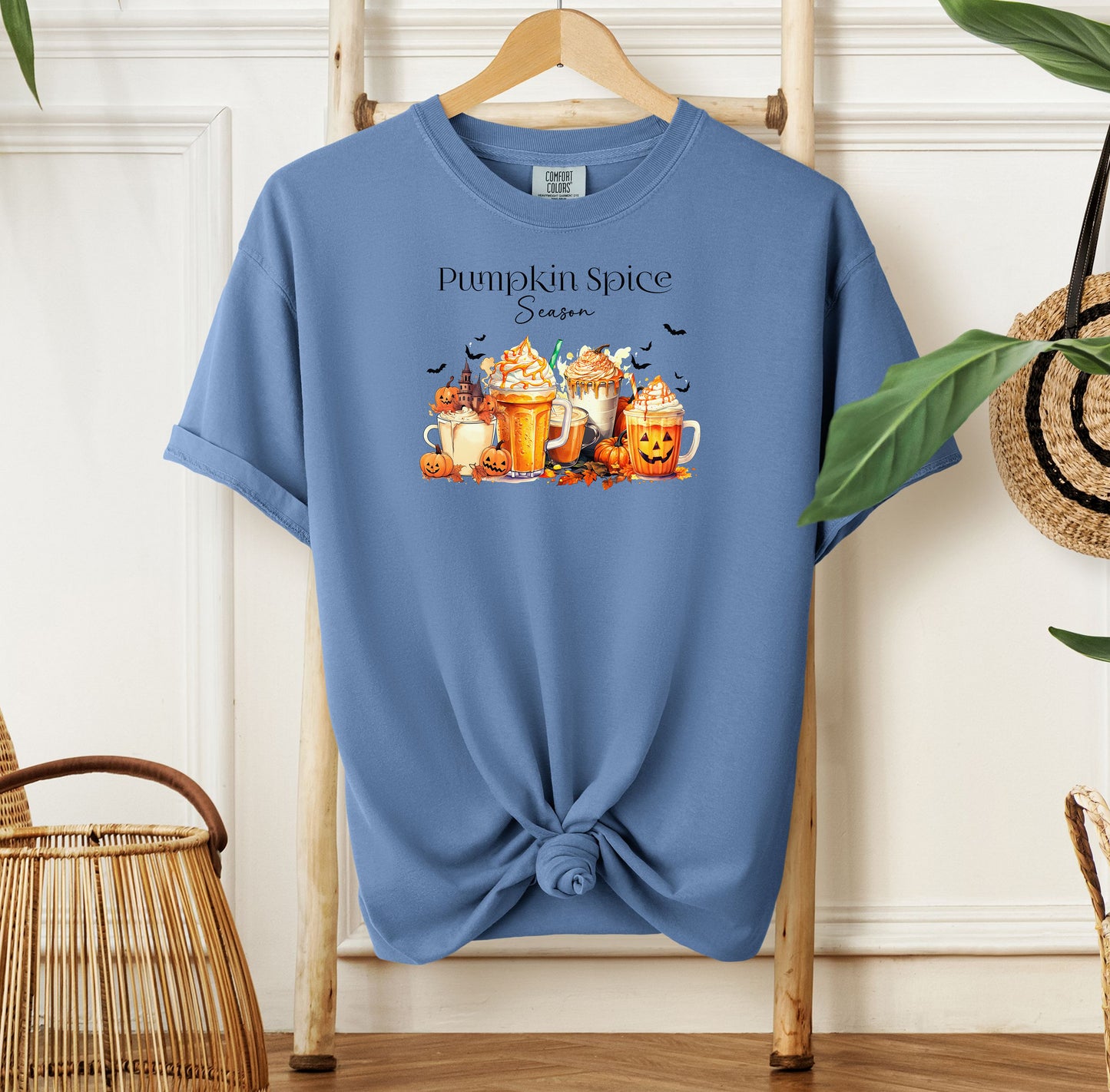 Washed Denim T-shirt featuring a “Pumpkin Spice Season” design with colorful autumn drinks topped with whipped cream, surrounded by pumpkins, jack-o’-lanterns, fall leaves, and flying bats. The cozy, festive artwork celebrates the love for pumpkin spice and autumn vibes, perfect for seasonal wear and fall enthusiasts.