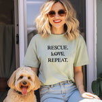 Rescue. Love. Repeat. T-shirt with bold black typography and cute kitten and puppy accents inside the letters. Shown on a bay unisex tee, this design is perfect for animal rescue advocates, pet lovers, and adoption supporters. Ideal for wearing to volunteer events, shelter fundraisers, or everyday outings to show pride in rescuing and loving animals.