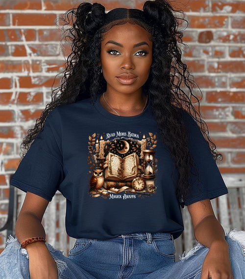 Person wearing a True Navy t-shirt featuring a whimsical "Read More Books, Magick Awaits" design. The graphic showcases an open enchanted book surrounded by candles, a crescent moon, owl, pocket watch, hourglass, and magical elements, creating a mystical and literary aesthetic perfect for book lovers and fantasy fans.
