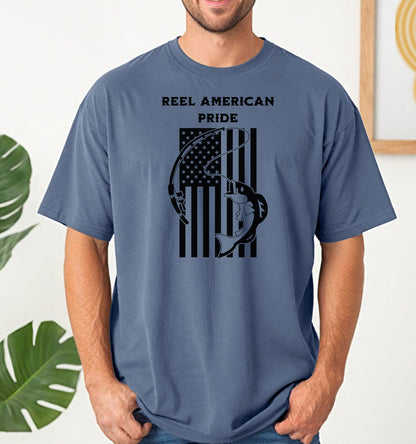 Reel American Pride T-shirt featuring a bold fishing-themed design with the phrase 'Reel American Pride' above an American flag graphic. A large fish is hooked on a fishing line overlaying the flag’s stripes. Printed on a blue jean unisex tee, this patriotic fishing shirt is perfect for anglers who love both their country and the sport. Ideal for summer outings, fishing trips, or casual everyday wear.