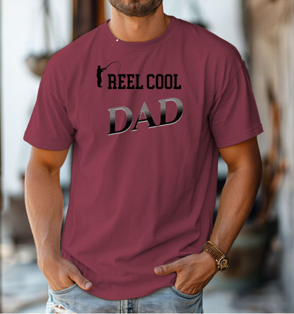Reel Cool Dad T-shirt featuring a playful fishing-themed design with the phrase 'Reel Cool Dad' and a silhouette of a fisherman casting a line. Printed on a Chili unisex tee, this fun graphic is perfect for dads who love fishing and spending time outdoors. Ideal for Father’s Day, birthdays, or casual wear for the proud angler dad.