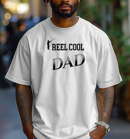 Reel Cool Dad T-shirt featuring a playful fishing-themed design with the phrase 'Reel Cool Dad' and a silhouette of a fisherman casting a line. Printed on a classic white unisex tee, this fun graphic is perfect for dads who love fishing and spending time outdoors. Ideal for Father’s Day, birthdays, or casual wear for the proud angler dad.
