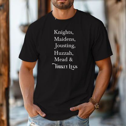 Person wearing a black Renaissance Faire-themed T-shirt featuring a playful list-style text: “Knights, Maidens, Jousting, Huzzah, Mead & Turkey Legs.” The design uses elegant medieval-inspired fonts to celebrate classic faire experiences, perfect for fairgoers who love the festive mix of tradition, adventure, and hearty food.