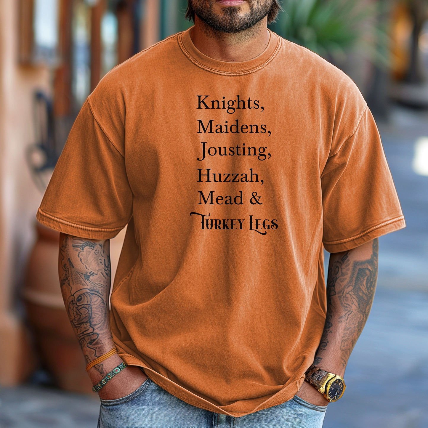 Person wearing a Yam Renaissance Faire-themed T-shirt featuring a playful list-style text: “Knights, Maidens, Jousting, Huzzah, Mead & Turkey Legs.” The design uses elegant medieval-inspired fonts to celebrate classic faire experiences, perfect for fairgoers who love the festive mix of tradition, adventure, and hearty food.