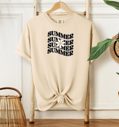 Ivory T-shirt featuring a retro wavy text design that repeats the word “SUMMER” four times in bold black vintage-style letters. A large white daisy with a yellow center overlaps the middle of the design, adding a cheerful floral touch. Perfect for sunny days, vacations, and casual outings, this shirt has a nostalgic, laid-back summer vibe.