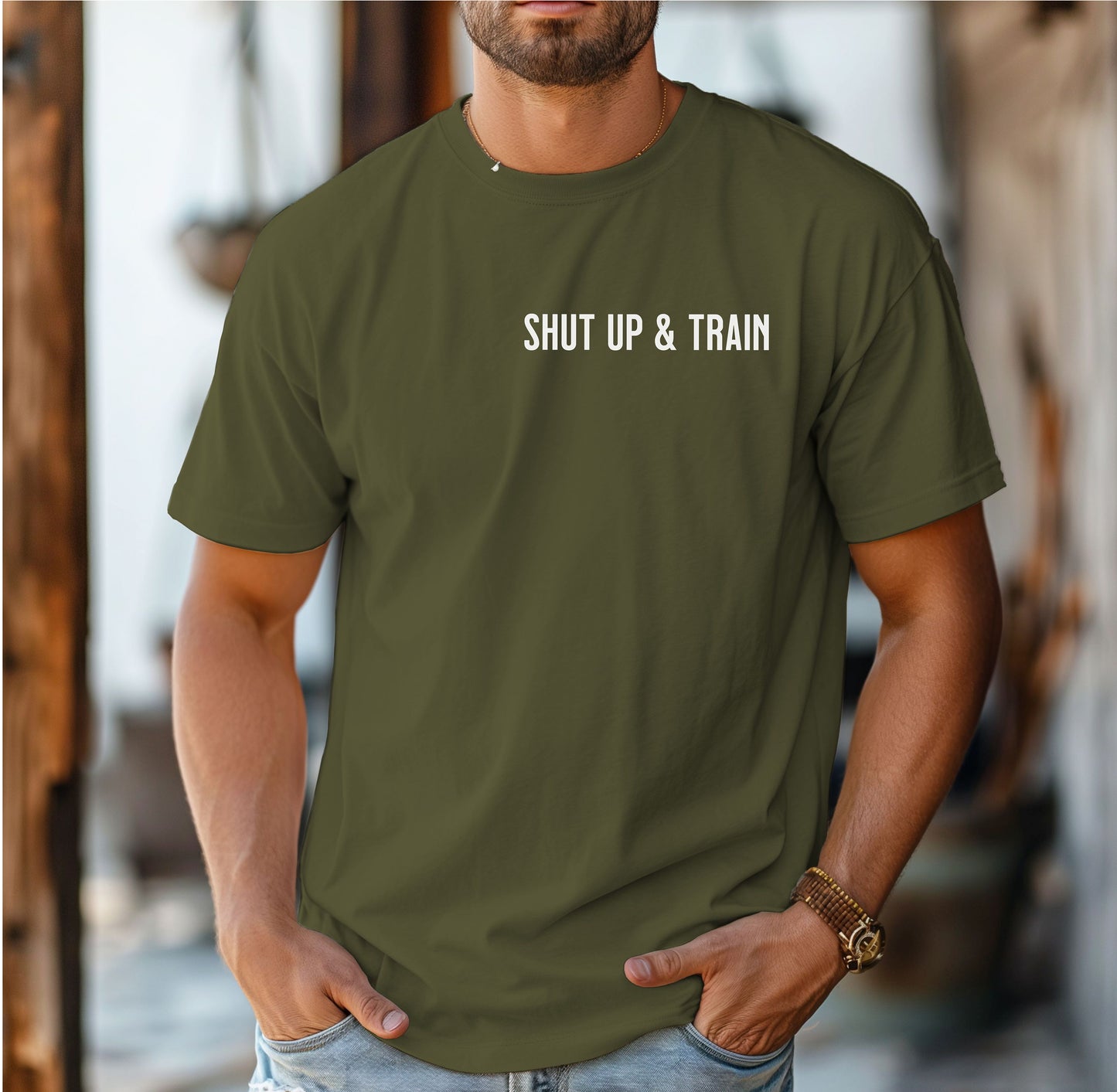 Person wearing a hemp color T-shirt featuring the bold motivational phrase “Shut Up & Train” in black text on the chest. The minimalist design delivers a powerful fitness message, perfect for athletes, bodybuilders, and gym-goers who embrace discipline and dedication in their workouts