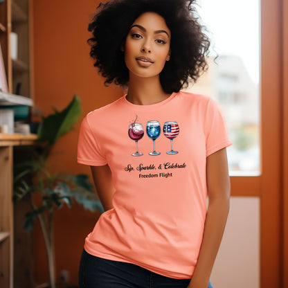 Sunset t-shirt featuring a festive 'Sip, Sparkle, & Celebrate – Freedom Flight' design with three wine glasses: one red with sparkles, one blue with stars, and one decorated with the American flag. Perfect for 4th of July, patriotic events, summer parties, and wine lovers celebrating in style.