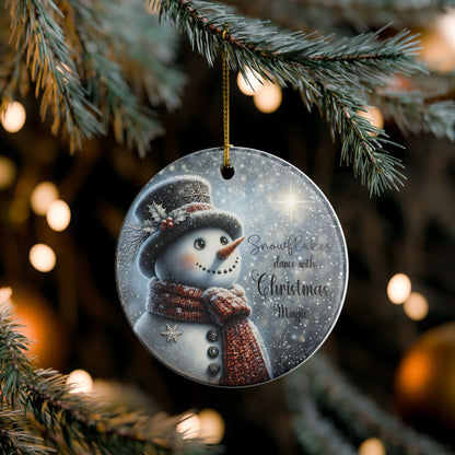 Christmas ornament with a snowman and magical snowflakes design hanging on a tree.