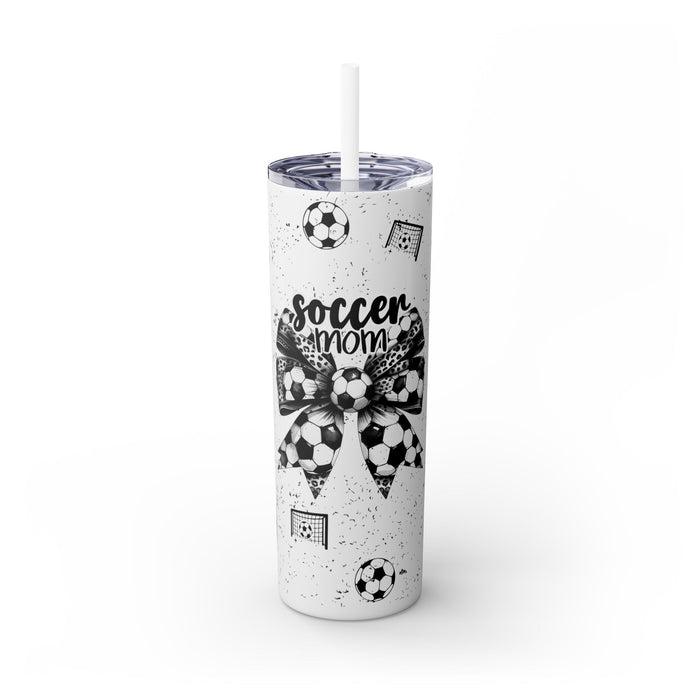 Soccer Mom Skinny Tumbler – 20 oz featuring a black-and-white coquette bow made of soccer balls with a leopard print accent. Surrounded by small soccer ball and goal illustrations on a speckled background, this stylish and durable tumbler is perfect for keeping drinks hot or cold. A fun and practical accessory for proud soccer moms to show their team spirit during practices, games, and everyday use.