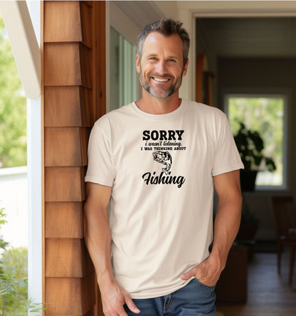 SORRY I wasn’t listening. I was thinking about Fishing' T-shirt featuring bold and script fonts with a detailed fish illustration. Printed on an ivory unisex tee, this humorous design is perfect for fishing enthusiasts who’d rather be on the water than anywhere else. Ideal for casual wear, fishing trips, or as a fun gift for anglers and dads who love the sport.