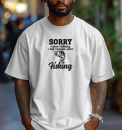 SORRY I wasn’t listening. I was thinking about Fishing' T-shirt featuring bold and script fonts with a detailed fish illustration. Printed on a classic white unisex tee, this humorous design is perfect for fishing enthusiasts who’d rather be on the water than anywhere else. Ideal for casual wear, fishing trips, or as a fun gift for anglers and dads who love the sport.