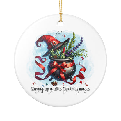 Ceramic ornament with a witch's hat, cauldron, and plants on a white background