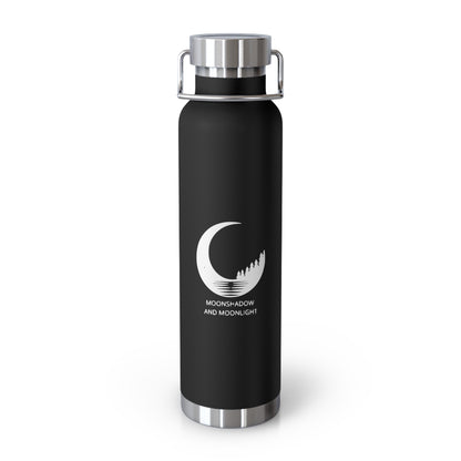 22 oz insulated water bottle with copper vacuum insulation, designed to keep drinks hot or cold for hours. Sleek black stainless steel flask features a modern crescent moon and pine tree logo with the words MoonShadow and MoonLight. Durable, leak-proof lid with handle makes it perfect for travel, gym, hiking, and everyday hydration.