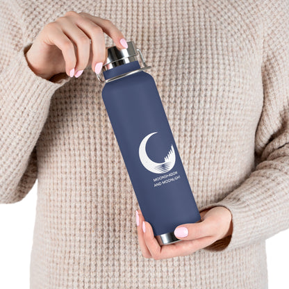 Person holding the navy water bottle with a logo against a beige background
