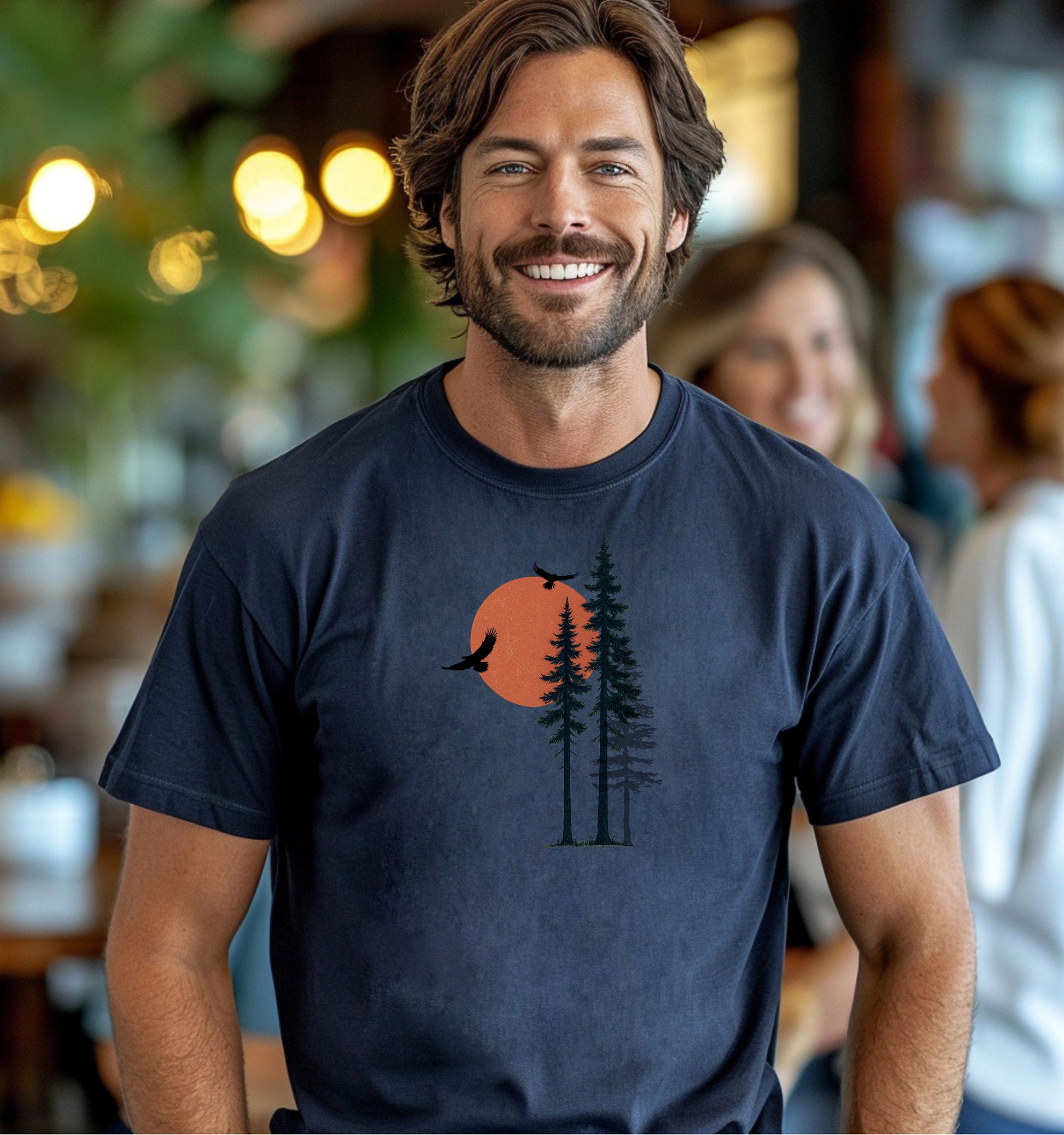 Sunset Pines & Soaring Eagles T-shirt featuring a minimalist nature design with tall pine trees silhouetted against a warm orange sun. Two eagles glide through the sky, adding a touch of wilderness and freedom. Printed on a midnight unisex tee, this nature-inspired graphic is perfect for outdoor lovers, hikers, and those who appreciate serene, scenic beauty.