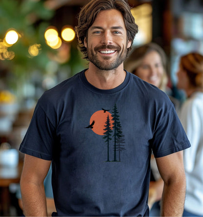 Sunset Pines & Soaring Eagles T-shirt featuring a minimalist nature design with tall pine trees silhouetted against a warm orange sun. Two eagles glide through the sky, adding a touch of wilderness and freedom. Printed on a midnight unisex tee, this nature-inspired graphic is perfect for outdoor lovers, hikers, and those who appreciate serene, scenic beauty.
