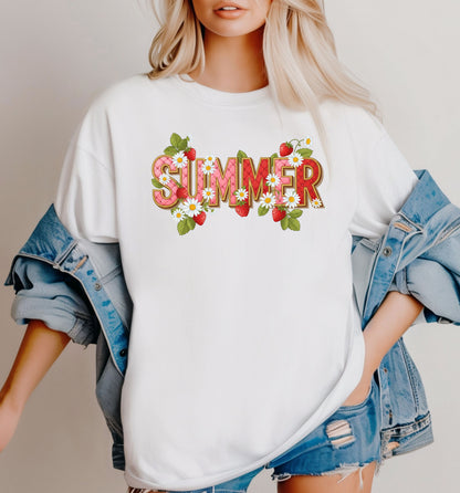White T-shirt featuring a vibrant “SUMMER” graphic decorated with red strawberries, green leaves, and white daisies. The fresh, playful design captures a bright and cheerful summer vibe, perfect for casual warm-weather outfits. 