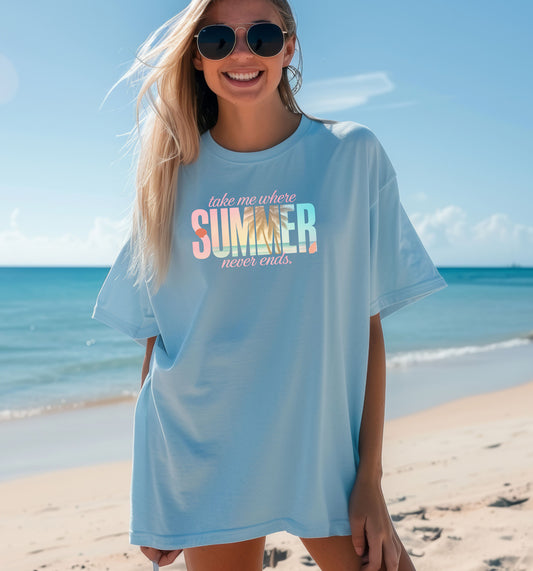 Ocean Blue T-shirt featuring the text “Take me where summer never ends” with the words “take me where SUMMER never ends”.  SUMMER is filled with a tropical beach scene including palm trees, seashells, and ocean waves. Perfect for beach lovers and summer enthusiasts, this vibrant vacation-themed shirt captures a fun, sunny vibe for casual outings, travel, or coastal adventures.