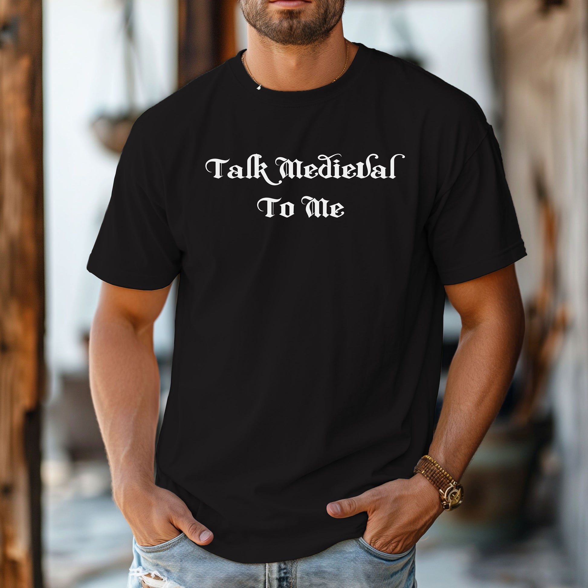 Black T-shirt featuring the phrase “Talk Medieval To Me” in a bold, Gothic-style blackletter font. Perfect for Renaissance Faire lovers, history buffs, and medieval festival goers who enjoy witty and playful designs that show off their love for knights, castles, and all things medieval.
