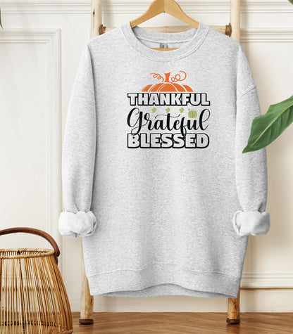 A “Thankful Grateful Blessed” Thanksgiving sweatshirt, featuring a festive pumpkin graphic, styled for cozy fall, autumn outfits and Thanksgiving celebrations