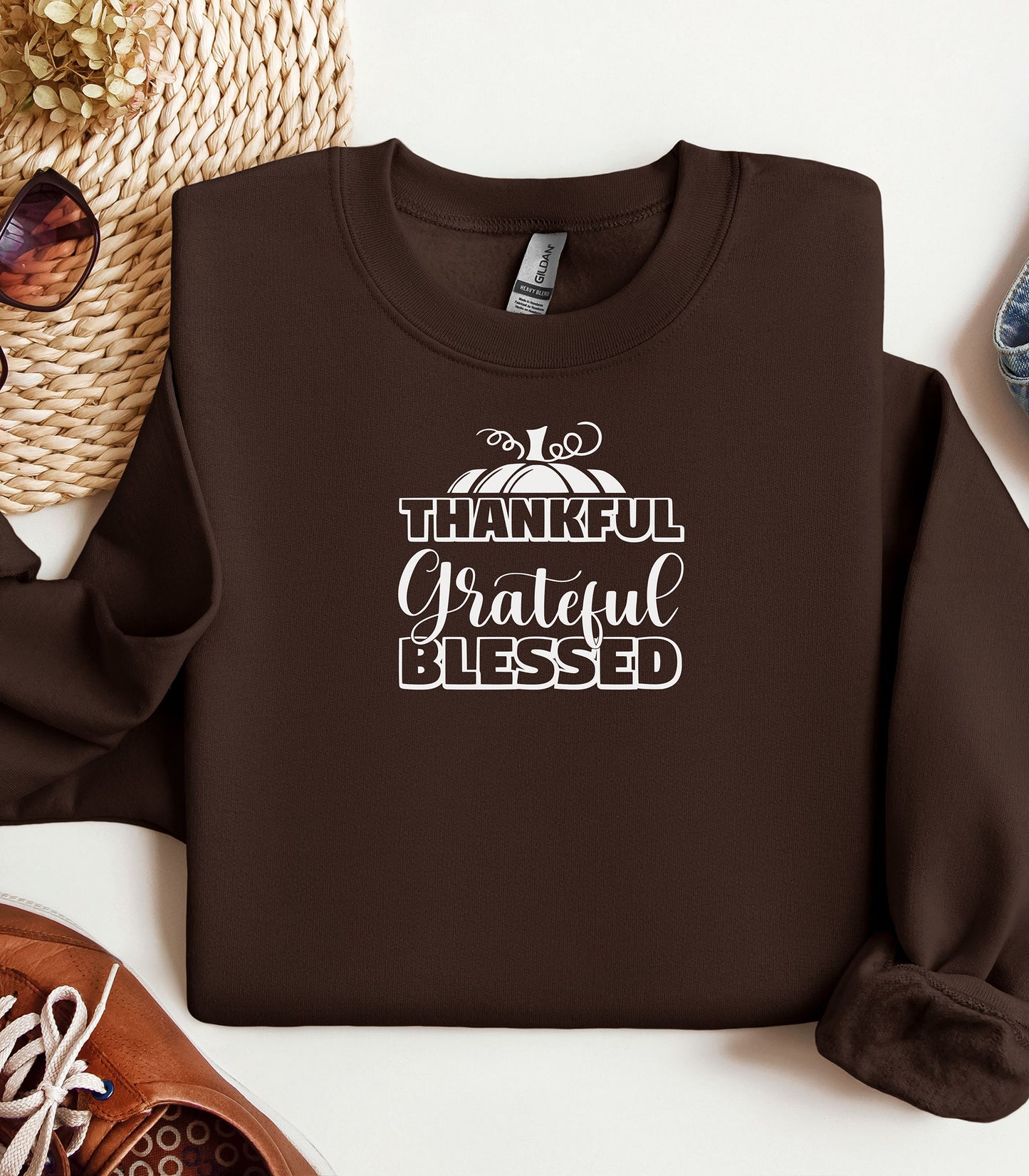 A “Thankful Grateful Blessed” Thanksgiving sweatshirt, featuring a festive pumpkin graphic, styled for cozy fall, autumn outfits and Thanksgiving celebrations