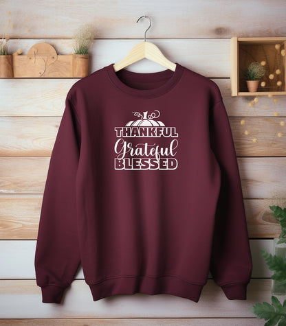 A “Thankful Grateful Blessed” Thanksgiving sweatshirt, featuring a festive pumpkin graphic, styled for cozy fall, autumn outfits and Thanksgiving celebrations