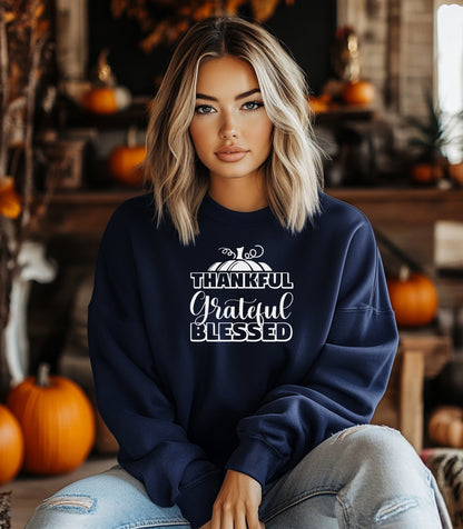 A “Thankful Grateful Blessed” Thanksgiving sweatshirt, featuring a festive pumpkin graphic, styled for cozy fall, autumn outfits and Thanksgiving celebrations