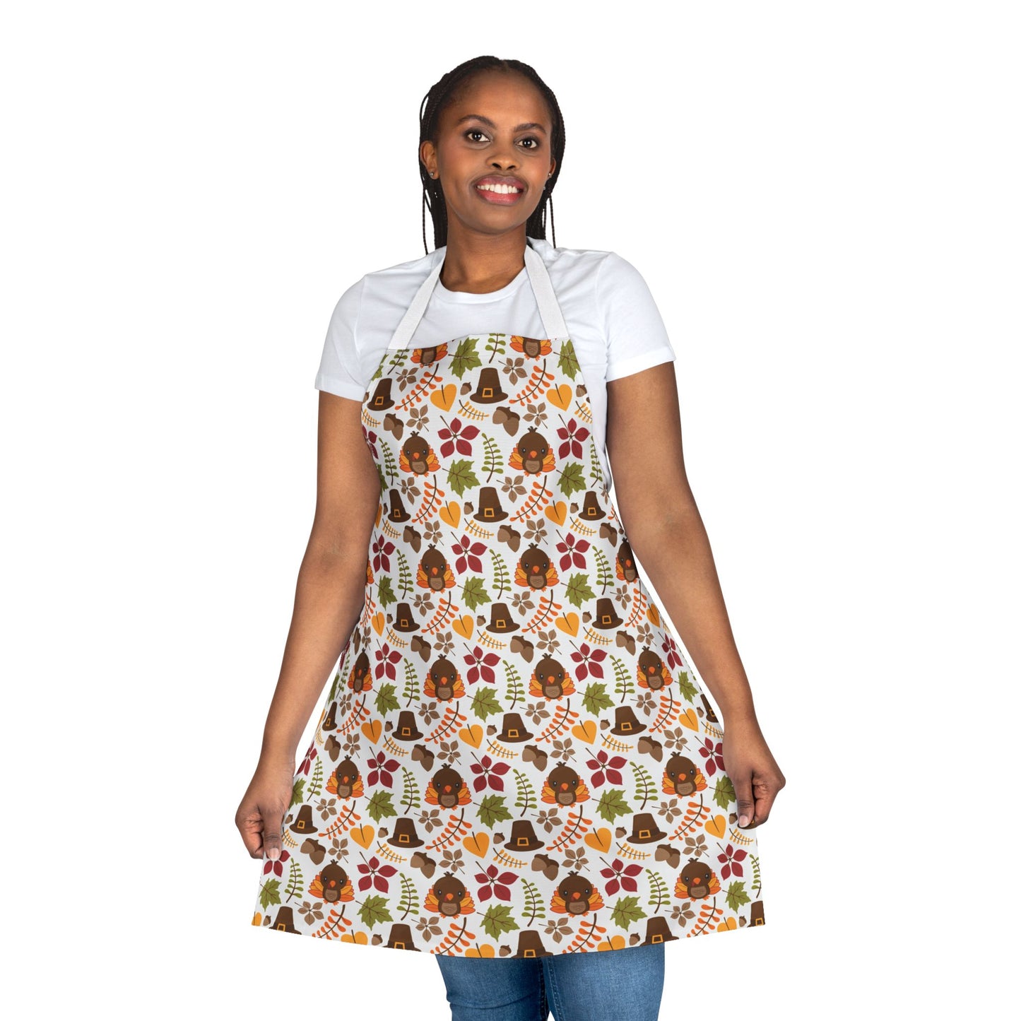 Woman wearing apron with a festive Thanksgiving pattern featuring turkeys, pilgrim hats, fall leaves, and autumn colors, perfect for holiday cooking and baking.