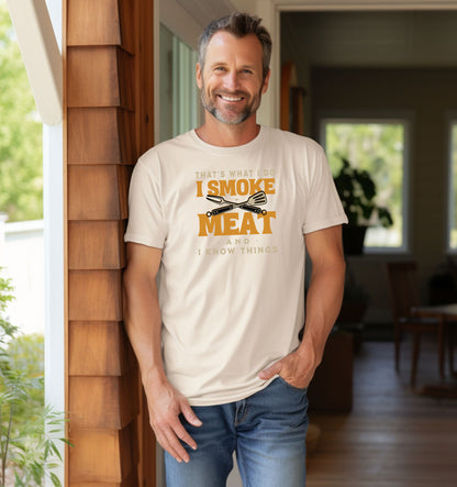 That's What I Do, I Smoke Meat & I Know Things T-shirt featuring bold text in yellow and white with crossed grilling tools at the center. Printed on an ivory unisex tee, this fun BBQ-themed design is perfect for grill masters and smoking enthusiasts. Ideal for Father’s Day, cookouts, and casual wear for those proud of their grilling skills and witty sense of humor.