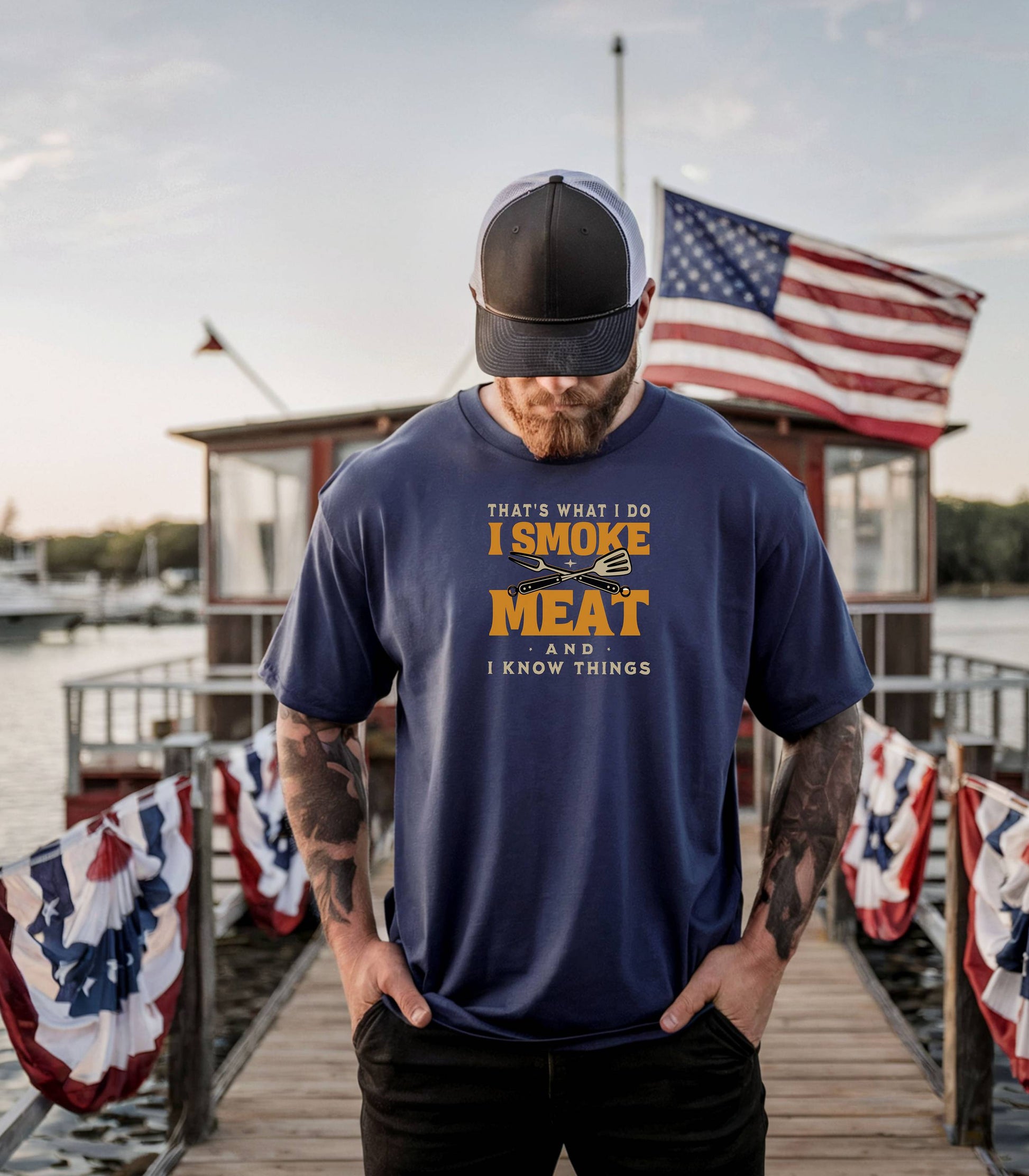 That's What I Do, I Smoke Meat & I Know Things T-shirt featuring bold text in yellow and white with crossed grilling tools at the center. Printed on a true navy unisex tee, this fun BBQ-themed design is perfect for grill masters and smoking enthusiasts. Ideal for Father’s Day, cookouts, and casual wear for those proud of their grilling skills and witty sense of humor.