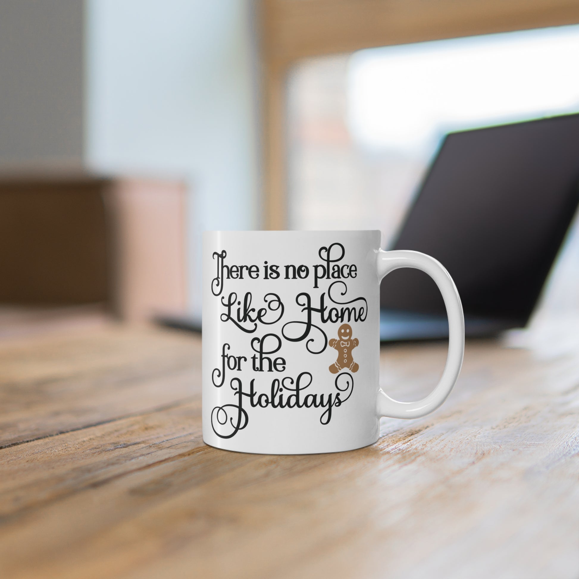 White ceramic mug with text and gingerbread man on a wooden surface