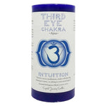 Third Eye Chakra pillar candle labeled "Ajna" with a deep indigo color and chakra symbol. Designed to enhance intuition and clarity, this candle is ideal for meditation, chakra rebalancing, and relaxation. Features a fragrance blend of jasmine and vetiver. Label includes affirmations and guidance for use in spiritual or sacred spaces. Crystal Journey Candles branding on bottom.