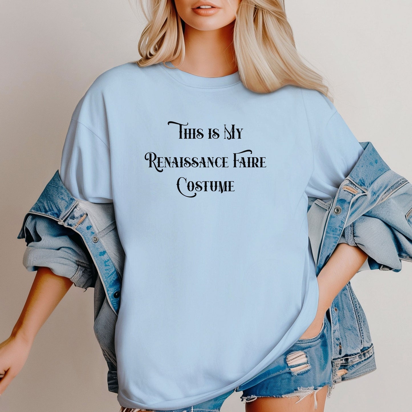 Chambray light blue T-shirt featuring the humorous phrase “This Is My Renaissance Faire Costume” in an elegant medieval-style font. Perfect for fairgoers who prefer a simple, casual outfit while enjoying the festivities, jousting, and entertainment at a Renaissance Faire. Ideal for fans of witty, themed apparel.