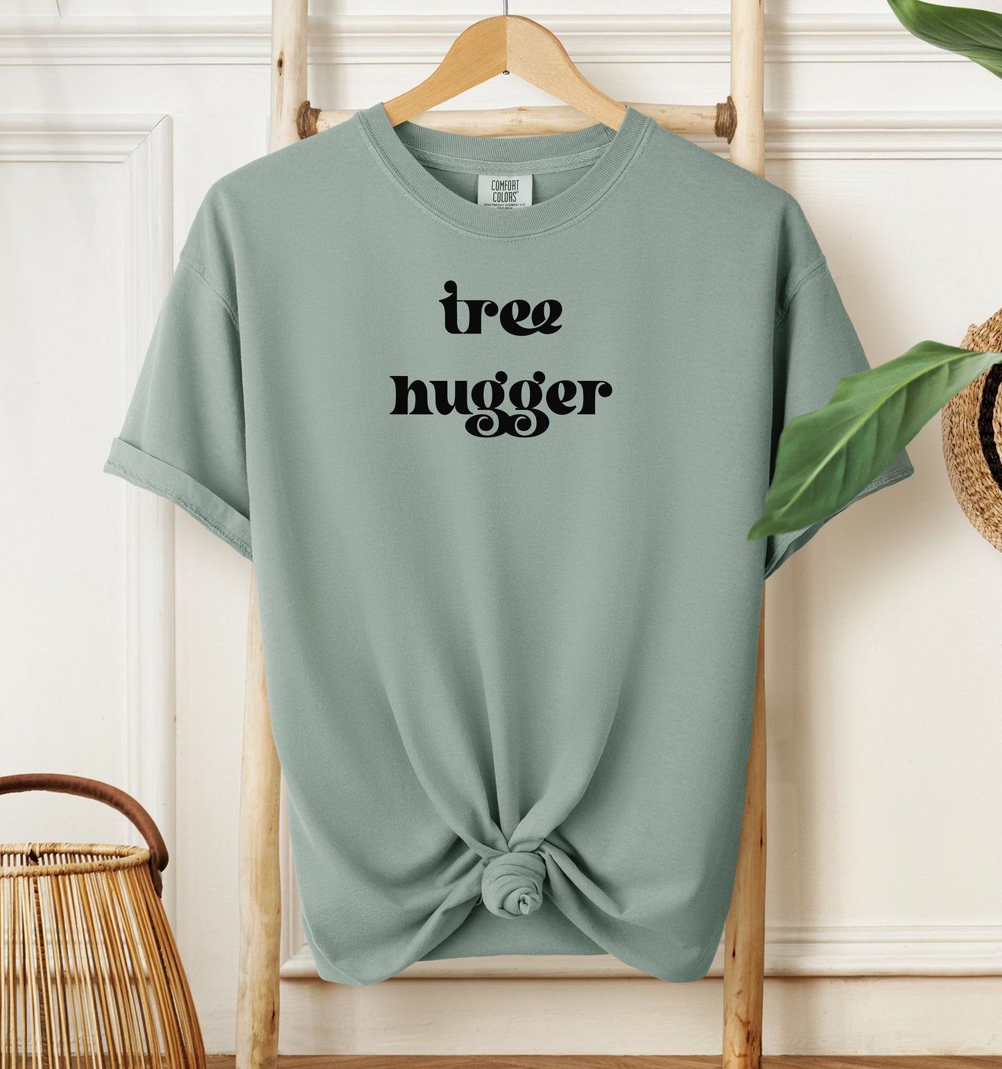 Tree Hugger T-shirt featuring bold retro-style black lettering on a bay unisex Comfort Colors tee. Perfect for nature lovers, environmentalists, and eco-conscious outdoor enthusiasts who appreciate a vintage vibe while showing their love for trees, conservation, and the planet.