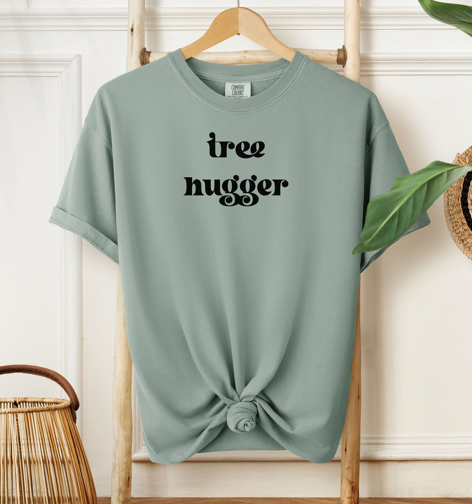 Tree Hugger T-shirt featuring bold retro-style black lettering on a bay unisex Comfort Colors tee. Perfect for nature lovers, environmentalists, and eco-conscious outdoor enthusiasts who appreciate a vintage vibe while showing their love for trees, conservation, and the planet.