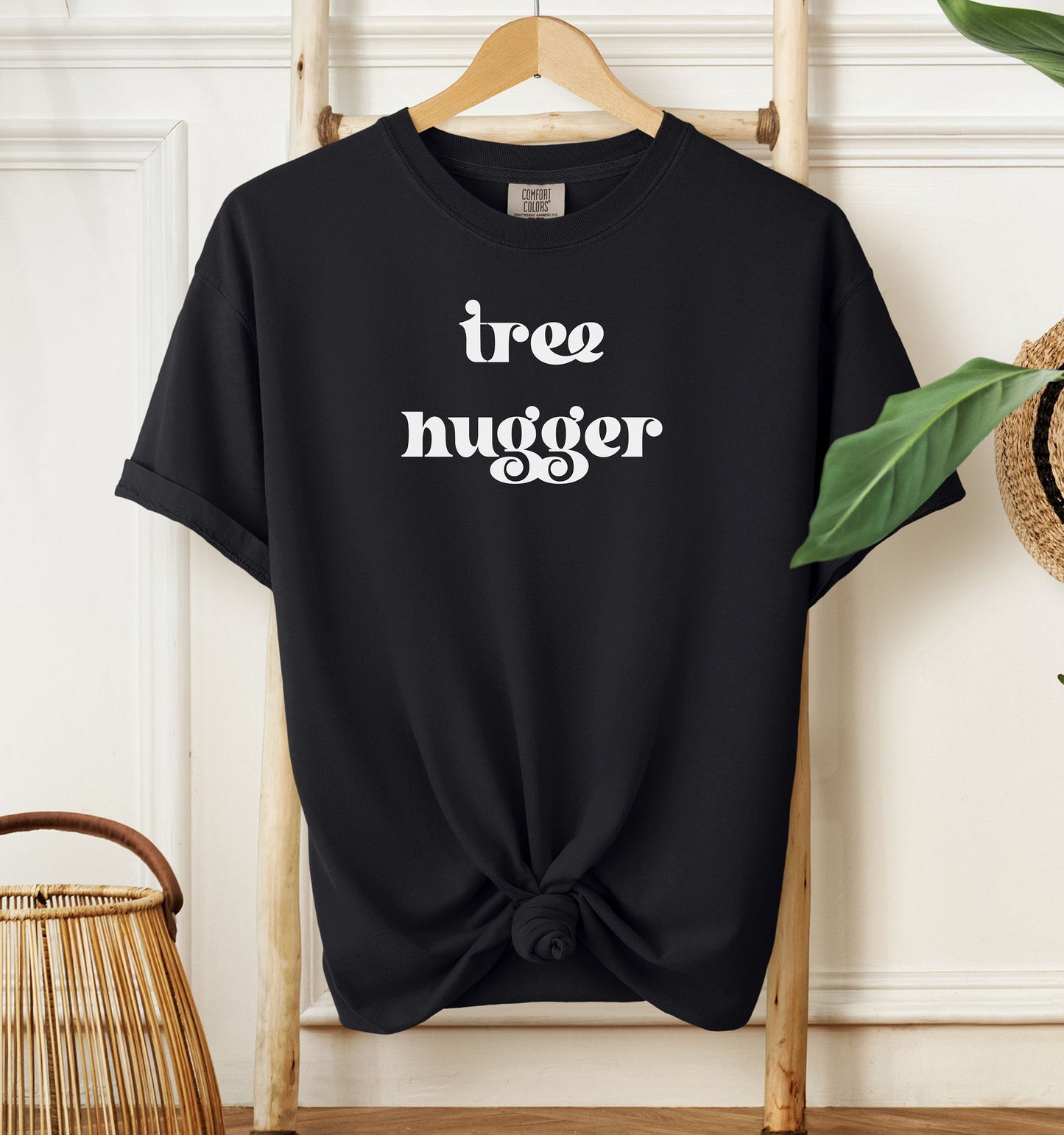 Tree Hugger T-shirt featuring bold retro-style white lettering on a black unisex Comfort Colors tee. Perfect for nature lovers, environmentalists, and eco-conscious outdoor enthusiasts who appreciate a vintage vibe while showing their love for trees, conservation, and the planet.
