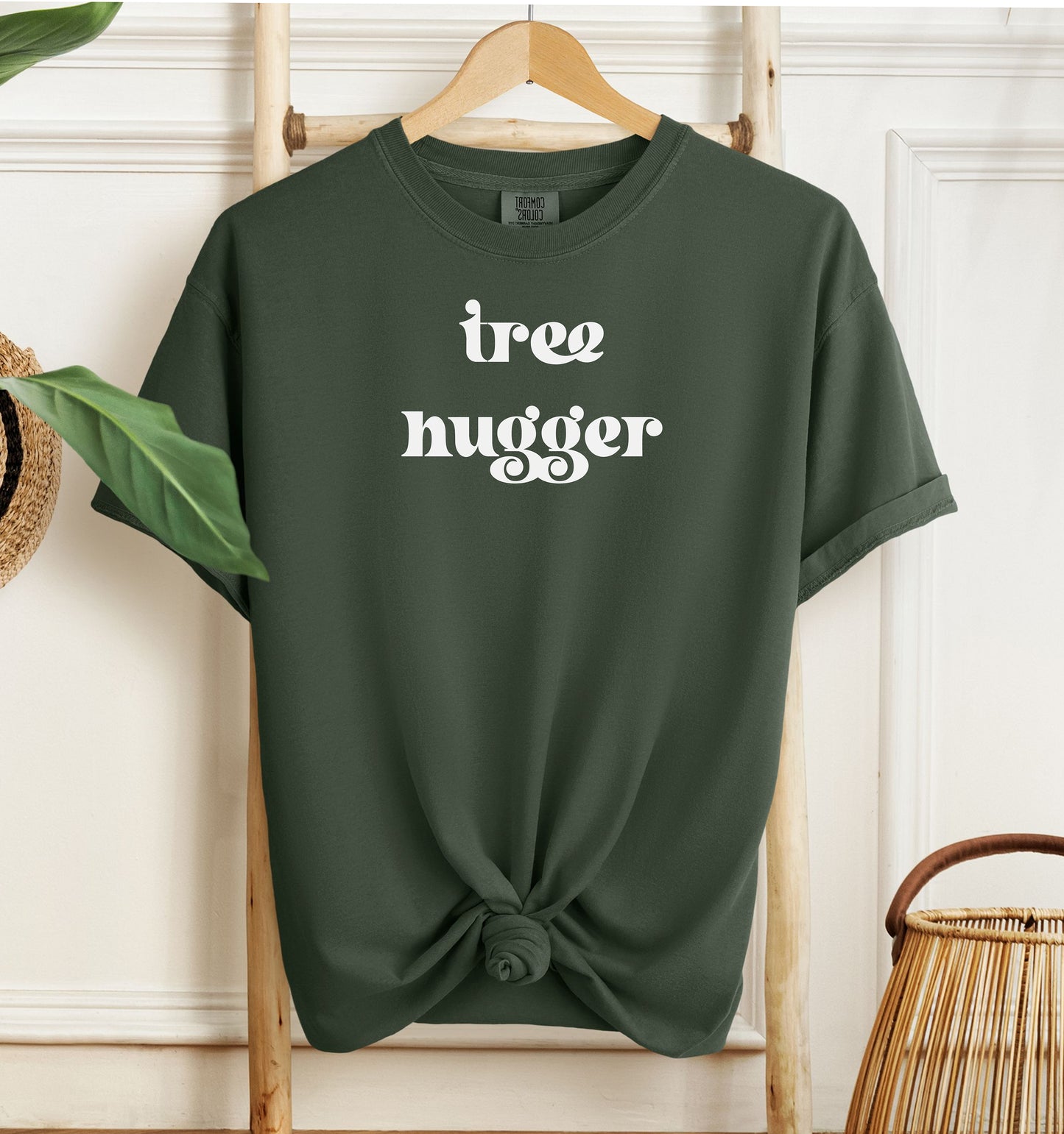 Tree Hugger T-shirt featuring bold retro-style white lettering on a hemp color unisex Comfort Colors tee. Perfect for nature lovers, environmentalists, and eco-conscious outdoor enthusiasts who appreciate a vintage vibe while showing their love for trees, conservation, and the planet.