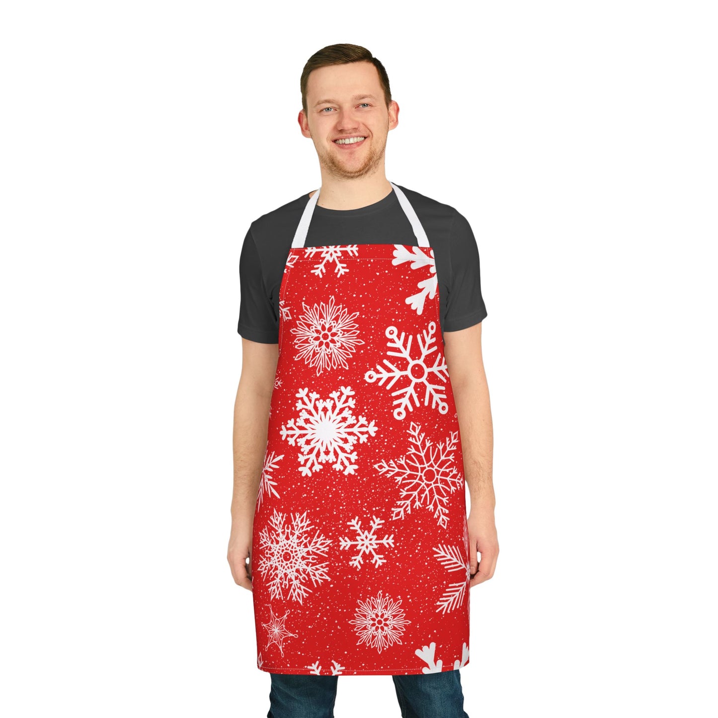 Apron with a festive red background covered in white snowflakes, creating a cheerful winter and Christmas-inspired design for holiday cooking.