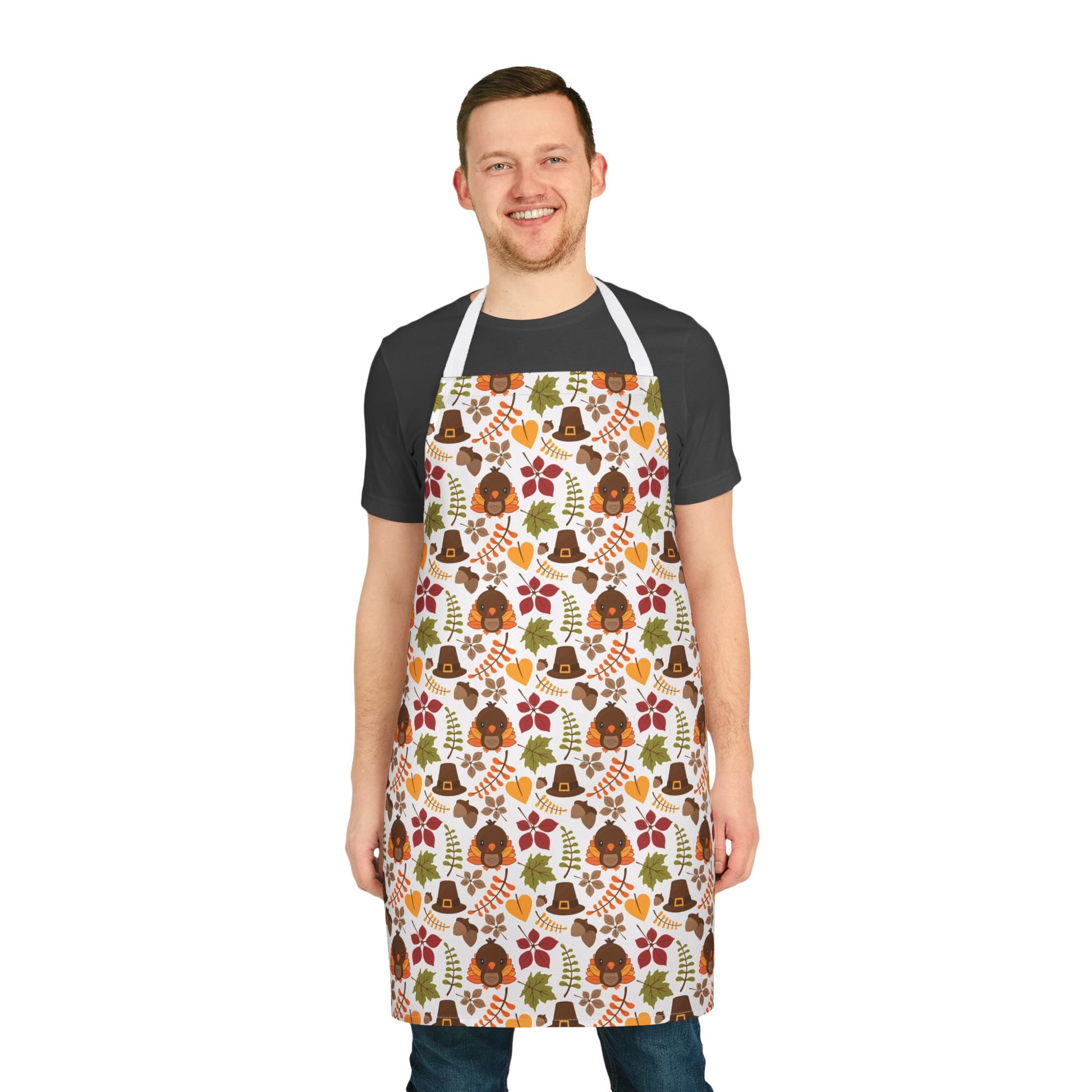 Apron with a festive Thanksgiving pattern featuring turkeys, pilgrim hats, fall leaves, and autumn colors, perfect for holiday cooking and baking.