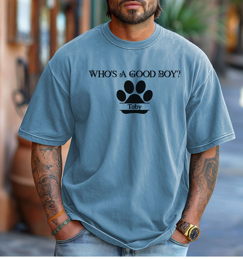 Man wearing a Washed Denim t-shirt that reads “Who’s a Good Boy?” above a black paw print graphic with the name “Toby”. The shirt is a playful and heartwarming tribute to a beloved pet—perfect for dog Dads and dog lovers.