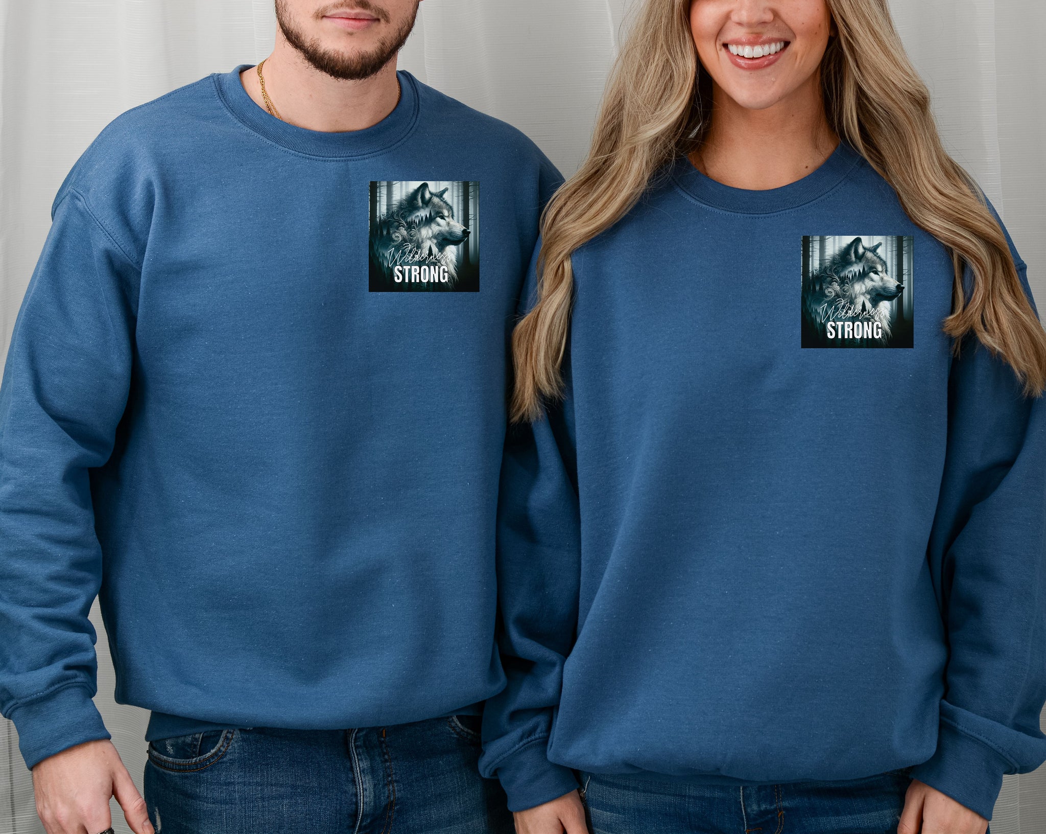 Indigo Blue Gildan sweatshirt featuring a “Wilderness Strong” design on the pocket area with a detailed illustration of a majestic wolf in a misty forest. The powerful graphic symbolizes resilience, strength, and connection to nature—ideal for outdoor lovers, wildlife fans, and those who embody the spirit of the wild.
