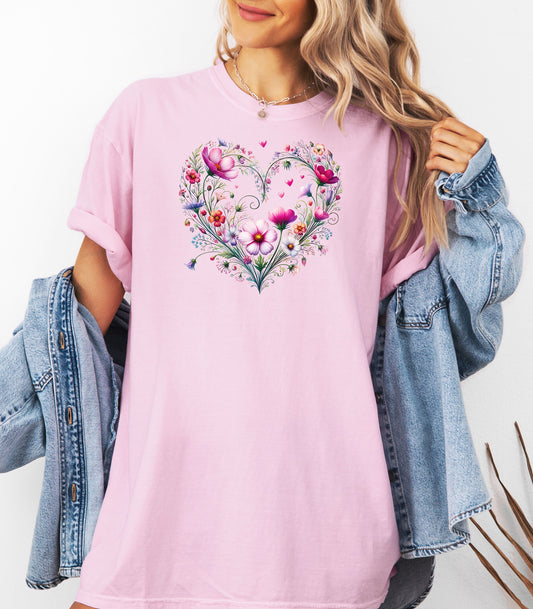 Person wearing a blossom t-shirt with a wildflower boho heart design, standing against a white background.