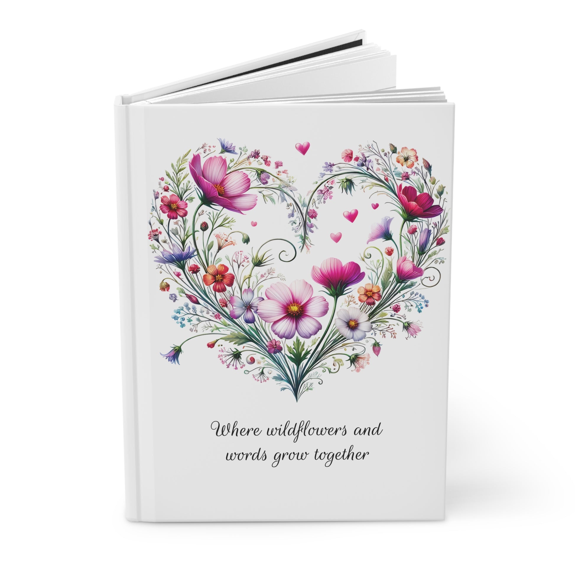 White journal open with wildflower floral heart design and text on a white background