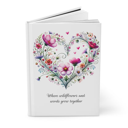 White journal open with wildflower floral heart design and text on a white background