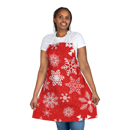 Apron with a festive red background covered in white snowflakes, creating a cheerful winter and Christmas-inspired design for holiday cooking.
